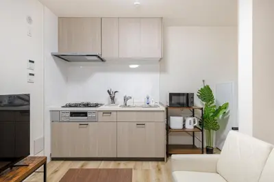 a kitchen with a sink and a stove at Shibuyahonmachi 1F in Tokyo