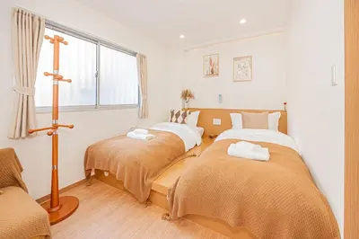 a bedroom with two beds and a window at \u65b0\u5c0f\u5ca9\u99c5\u5f92\u6b696\u5206 50\u5e73 2DK \u6709\u53a8\u623f \u6771\u4eac13\u5206 Skytree15\u5206 in Tokyo