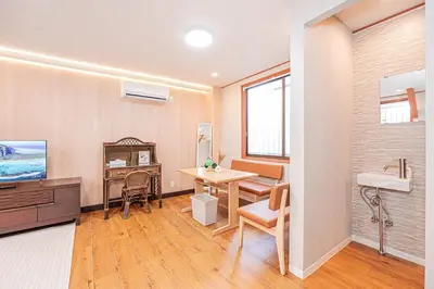 a room with a desk and a table and a sink at Asuka Guesthouse \u5bbf-\u98db\u9ce5 in Tokyo
