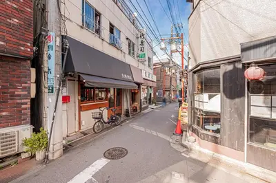 a city street with a cat sticking its head out of a window at Asuka Guesthouse \u5bbf-\u98db\u9ce5 in Tokyo