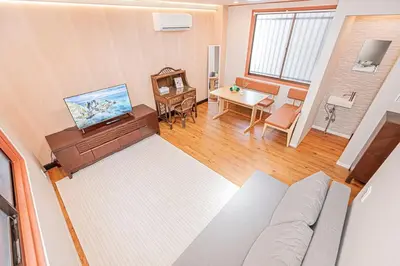 an overhead view of a living room with a couch and a table at Asuka Guesthouse \u5bbf-\u98db\u9ce5 in Tokyo