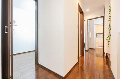 a hallway with white walls and a large mirror at Fukuei Stay Premium in Tokyo