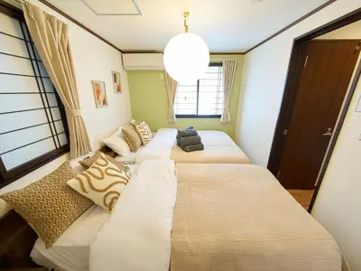 four beds in a room with a window at The Prime TOKYO SKYTREE - Vacation STAY 66636v in Tokyo