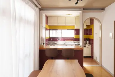 a kitchen with a wooden table and two chairs at The Sakura House - Great access to Ikebukuro, Shinjuku, Shibuya, more - Private 4DK detached house - 1 shower and 2 toilets - Experience Japanese culture in Tokyo