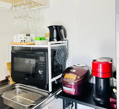 a kitchen with a toaster and a microwave on a counter at sunflower house in Tokyo