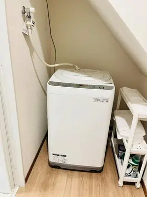 a washer and dryer sitting in the corner of a room at Arashi - Ikebukuro 10 min Shinjuku 20 min in Tokyo