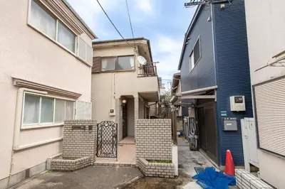 an alleyway between two buildings with a house at \u6c60\u888b1\u4e01\u76ee in Tokyo