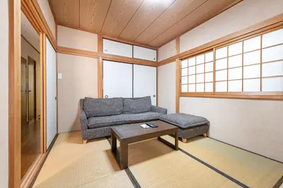 a living room with a couch and a coffee table at \u6c60\u888b1\u4e01\u76ee in Tokyo