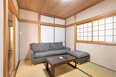 a living room with a couch and a coffee table at \u6c60\u888b1\u4e01\u76ee in Tokyo