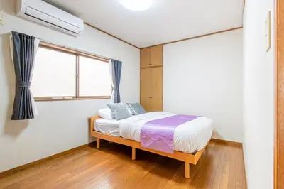 a bedroom with a bed and a window at \u6c60\u888b1\u4e01\u76ee in Tokyo
