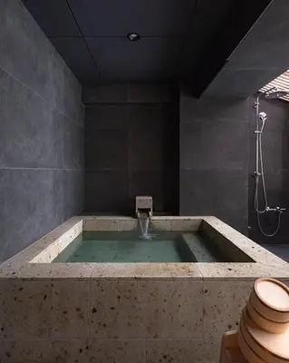 a bathroom with a bath tub with a toilet at suirow \u7fe0\u697c in Tokyo