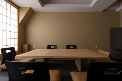 a conference room with a wooden table and chairs at suirow \u7fe0\u697c in Tokyo