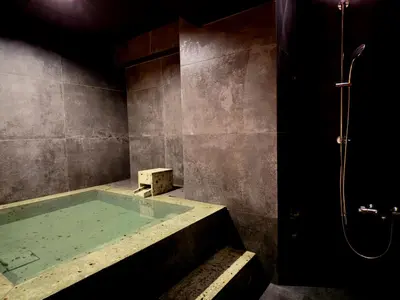 a bathroom with a tub with a shower at suirow \u7fe0\u697c in Tokyo