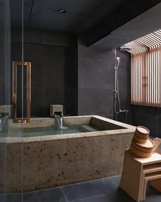 a bathroom with a tub with a shower and a sink at suirow \u7fe0\u697c in Tokyo