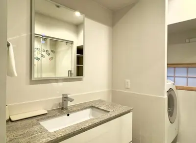 a bathroom with a sink and a washing machine at suirow \u7fe0\u697c in Tokyo