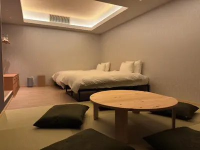 a small room with two beds and a table at suirow \u7fe0\u697c in Tokyo