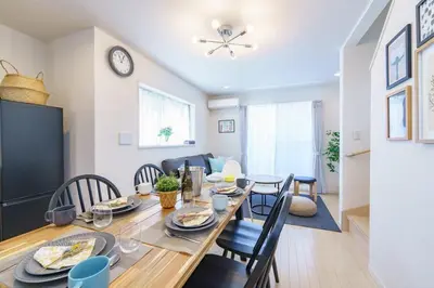 a dining room and living room with a table and chairs at -CasaBlue Ikebukuro House- 15-minute walk from Ikebukuro Station in Tokyo