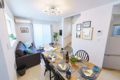 a dining room and living room with a table and chairs at -CasaBlue Ikebukuro House- 15-minute walk from Ikebukuro Station in Tokyo