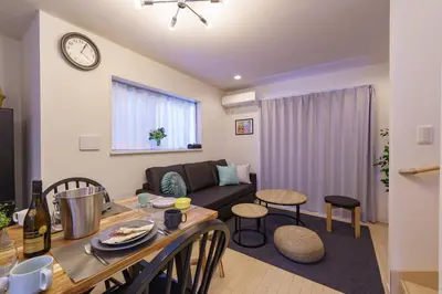 a living room with a couch and a table at -CasaBlue Ikebukuro House- 15-minute walk from Ikebukuro Station in Tokyo