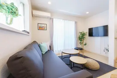 a living room with a couch and a table at -CasaBlue Ikebukuro House- 15-minute walk from Ikebukuro Station in Tokyo