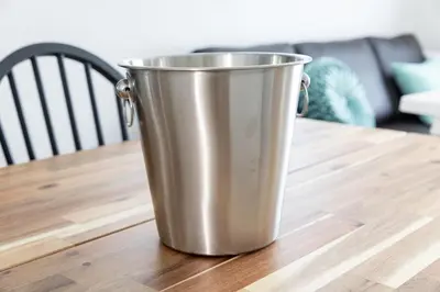 a metal bucket sitting on top of a wooden table at -CasaBlue Ikebukuro House- 15-minute walk from Ikebukuro Station in Tokyo