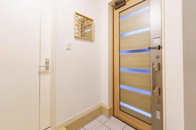 a wooden door in a room with a tile floor at -CasaBlue Ikebukuro House- 15-minute walk from Ikebukuro Station in Tokyo
