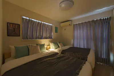 a bedroom with two beds and a window at -CasaBlue Ikebukuro House- 15-minute walk from Ikebukuro Station in Tokyo