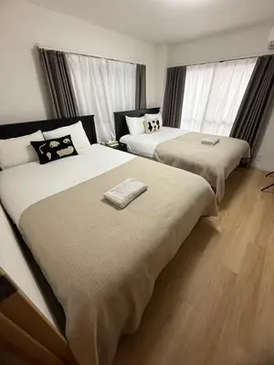 two beds in a hotel room with windows at Otsuka, Bunkyo-ku, House-BK0457 in Tokyo