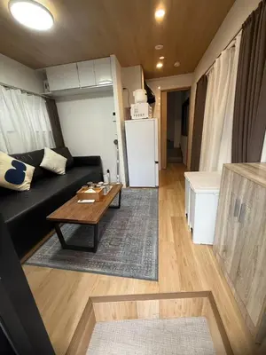 a living room with a black couch and a table at Otsuka, Bunkyo-ku, House-BK0457 in Tokyo