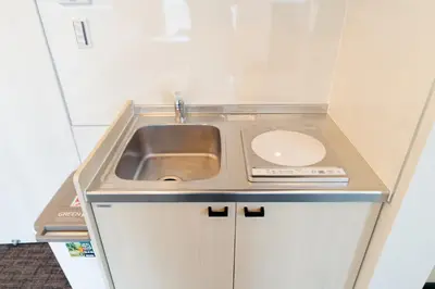 a small kitchen with a sink and a counter at Sunshine Inn 456 - Economic APT in Tokyo Tranquil Block, with Direct Access to Ginza & Akihabara in Tokyo