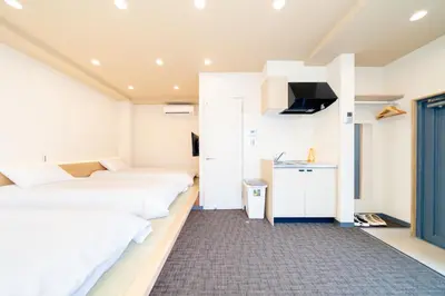 a room with two beds and a tv in it at Sunshine Inn 456 - Economic APT in Tokyo Tranquil Block, with Direct Access to Ginza & Akihabara in Tokyo
