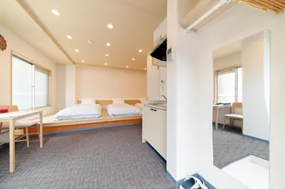 a bedroom with a bed and a table and chairs at Sunshine Inn 456 - Economic APT in Tokyo Tranquil Block, with Direct Access to Ginza & Akihabara in Tokyo