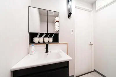 a bathroom with a sink and a mirror at Sunshine Inn 456 - Economic APT in Tokyo Tranquil Block, with Direct Access to Ginza & Akihabara in Tokyo