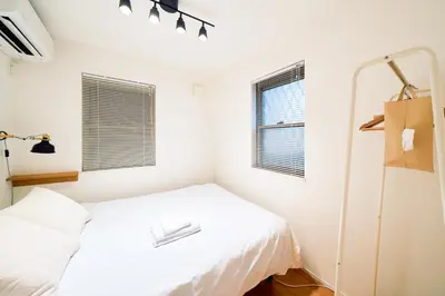 a white bedroom with a bed and a window at SATELLITE HOTEL Yoyogi Park \u30b5\u30c6\u30e9\u30a4\u30c8\u30db\u30c6\u30eb\u4ee3\u3005\u6728\u516c\u5712 in Tokyo