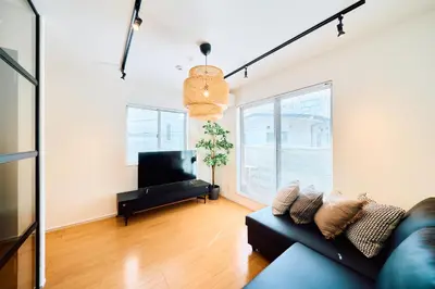 a living room with a couch and a television at SATELLITE HOTEL Yoyogi Park \u30b5\u30c6\u30e9\u30a4\u30c8\u30db\u30c6\u30eb\u4ee3\u3005\u6728\u516c\u5712 in Tokyo