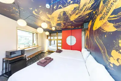 a bedroom with a large bed and a painting on the wall at Luum Stay Shibuya 2 in Tokyo