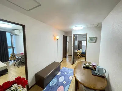 a living room with a couch and a table at \u8c4a\u5cf6\u5927\u585a\u685c\u6c11\u5bbf in Tokyo