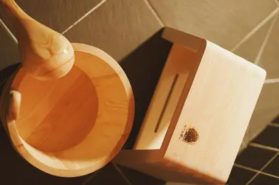 a toilet with a wooden seat and a roll of toilet paper at \u6d45\u8349\u82d1 in Tokyo
