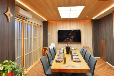 a conference room with a long wooden table and chairs at \u6d45\u8349\u82d1 in Tokyo