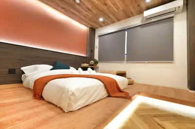 a bedroom with a large bed and a large screen at \u6d45\u8349\u82d1 in Tokyo