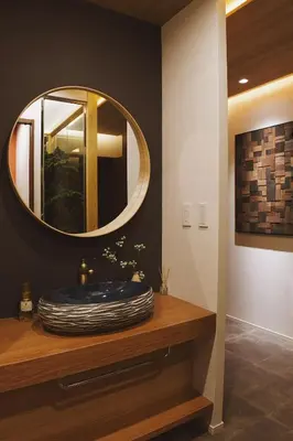 a bathroom with a round mirror on a counter at \u6d45\u8349\u82d1 in Tokyo