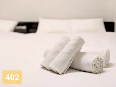 a pile of towels sitting on top of a bed at Arms Nishi-Shinjuku in Tokyo