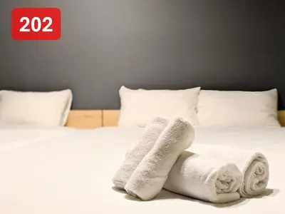 a pair of white socks and towels on a bed at Arms Nishi-Shinjuku in Tokyo