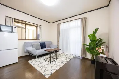a living room with a couch and a table at \u5c0f\u5ca93LDK\u4e00\u8ed2\u5bb6 3 BDR House in Koiwa \u548c\u5fc3\u306e\u5bb6 in Tokyo