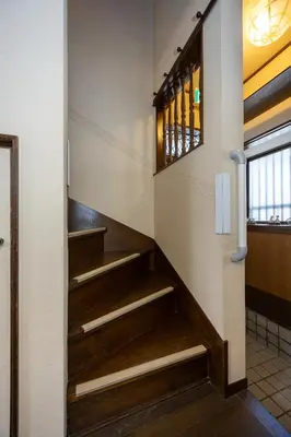a staircase in a building with wooden steps at \u5c0f\u5ca93LDK\u4e00\u8ed2\u5bb6 3 BDR House in Koiwa \u548c\u5fc3\u306e\u5bb6 in Tokyo