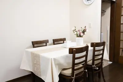 a table with chairs and a vase of flowers on it at \u5c0f\u5ca93LDK\u4e00\u8ed2\u5bb6 3 BDR House in Koiwa \u548c\u5fc3\u306e\u5bb6 in Tokyo