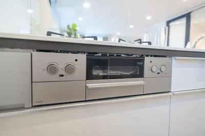 a silver oven on a counter in a kitchen at Mi-Villa SHIBUYA HONMACHI in Tokyo