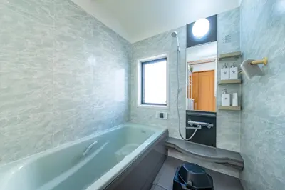 a bathroom with a bath tub and a window at ZEN HOTEL Haven in Tokyo