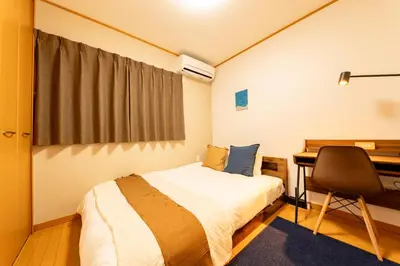 a bedroom with a bed and a desk and a chair at ZEN HOTEL Haven in Tokyo