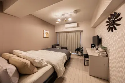 a bedroom with a bed and a desk and a television at R STAY Oshiage 201 in Tokyo